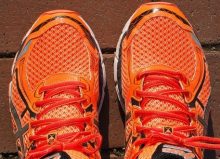 pair of bright orange trainers on the ground