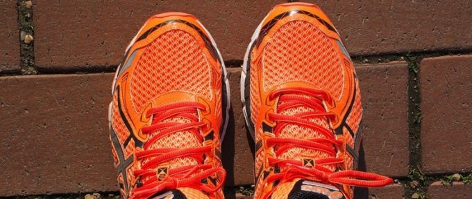 pair of bright orange trainers on the ground