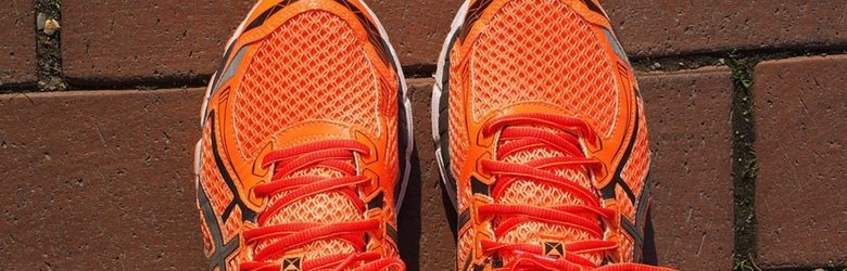 pair of bright orange trainers on the ground