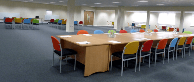 spacious training room with table and chairs