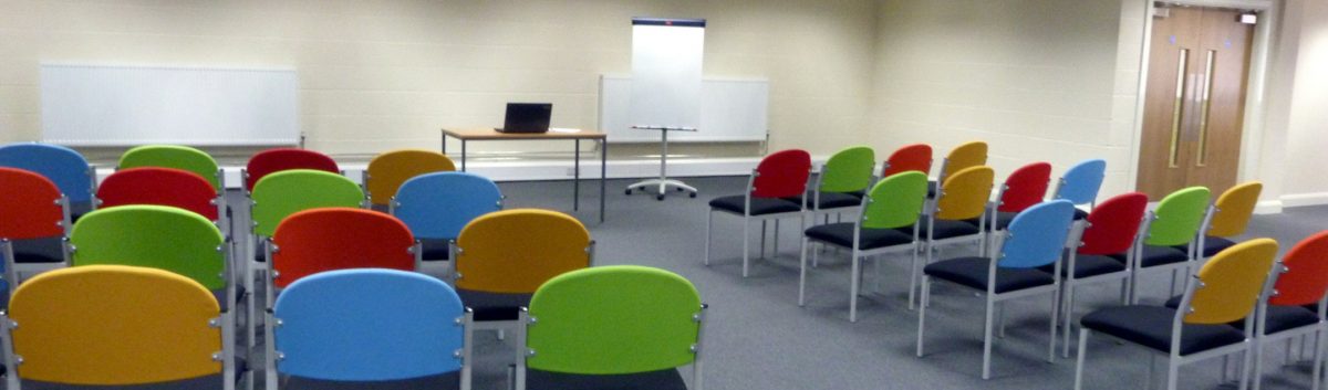 training room at redbank house with chairs and laptop