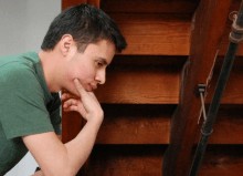 man thinking feeling anxious by stairwell