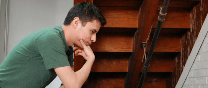 man thinking feeling anxious by stairwell