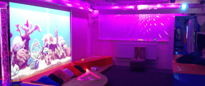 multisensory room redbank house with purple lighting and fish projection screen