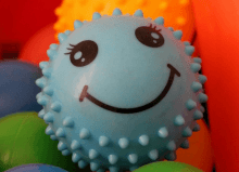 blue smiley face sensory ball toy