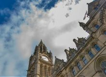 manchester town hall with cloudy sky