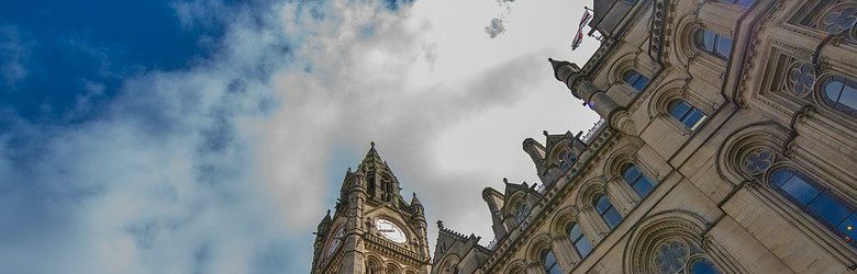 manchester town hall with cloudy sky