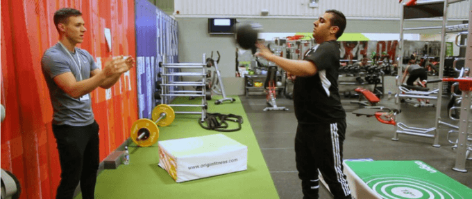 ben andrews in the gym helping disabled person