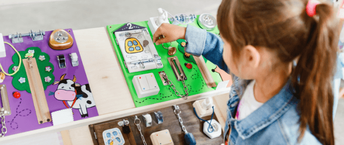 young girl playing with sensory toys