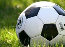 close up of football on a grass pitch