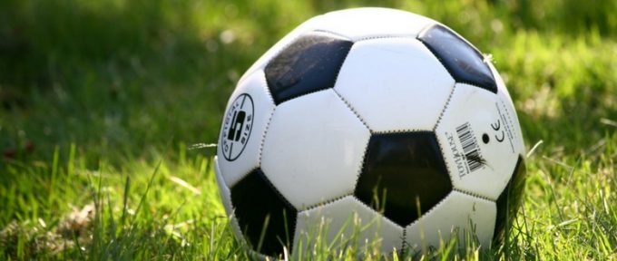 close up of football on a grass pitch