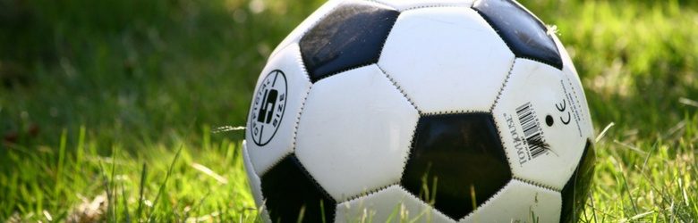 close up of football on a grass pitch