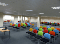 training room 2 at redbank house in manchester with colourful chairs and space