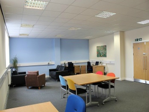 office space with desk table and chairs