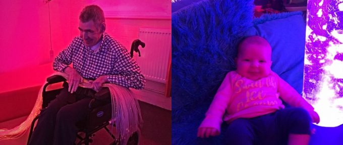 man playing with fibre optics and a baby smiling