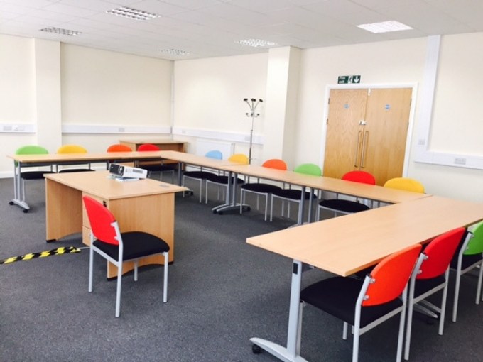 training room with u-shaped layout desk and chairs