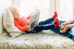 toddler looking at a book