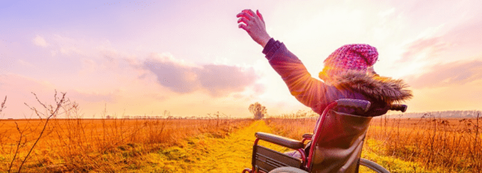 happy girl in wheelchair showing independence